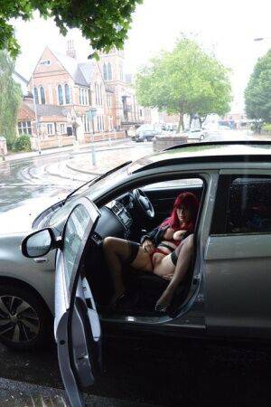 Mature redhead Barby Slut gets naked in public places on a wet day on nudesceleb.com