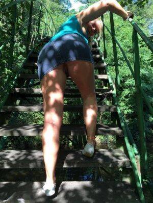 Blonde amateur Sweet Susi lifts her dress over her ass on outdoors stairs on nudesceleb.com