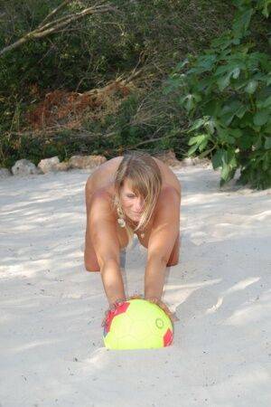 Mature woman Sweet Susi models totally naked on a patch of sand in a backyard on nudesceleb.com