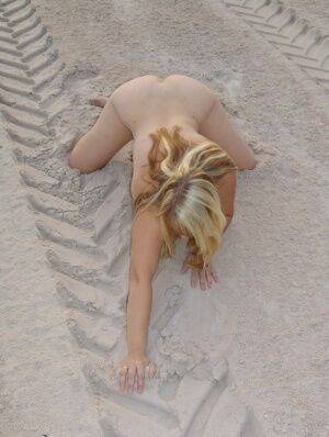 Mature blonde Sweet Susi doffs a bikini to pose naked in a sand pit on nudesceleb.com