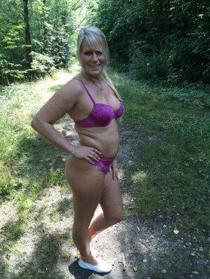 Chubby amateur MILF Sweet Susi sheds bikini bra to pose topless in the woods on nudesceleb.com