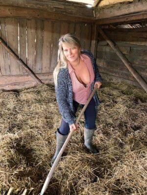 Overweight amateur Sweet Susi strips naked while forking hay in a mow on nudesceleb.com