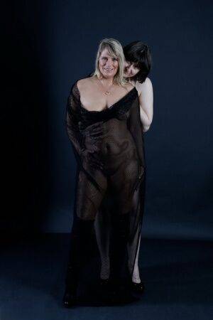 Older amateur Sweet Susi and her lesbian lover model naked together on nudesceleb.com