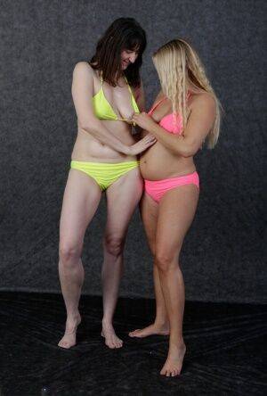 Blonde amateur Sweet Susi and her lesbian friend fondle each other in bikinis on nudesceleb.com