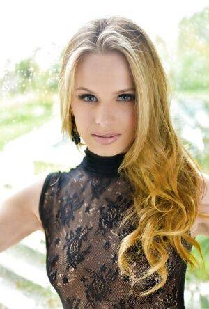 Blonde babe model Jillian Janson strutting outdoors in black bodystocking on nudesceleb.com