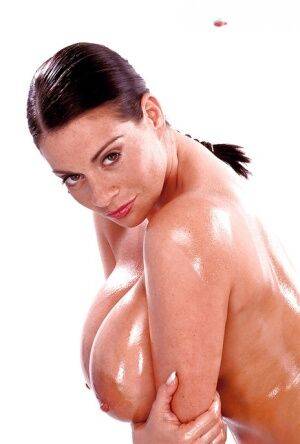 Brunette mom Linsey Dawn McKenzie oiling massive juggs, beaver and ass on nudesceleb.com