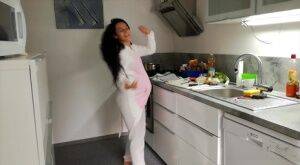 Horny and pregnant Lexi Dona undressing in the kitchen to sate her appetite on nudesceleb.com