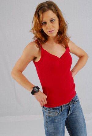 Natural redhead Sabine shows off her black G-shock watch while fully clothed on nudesceleb.com