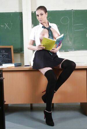 Uniformed schoolgirl Connie Carter is posing in sexy high heels on nudesceleb.com