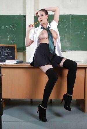 Clothed babe Connie Carter is showing off in a school uniform on nudesceleb.com