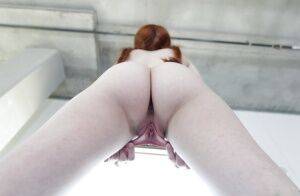 Young redhead Dolly Little revealing shaved pussy in pigtails and socks on nudesceleb.com