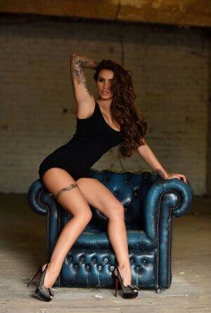 Tattooed model Gemma Massey works clear of a black dress to pose nude in heels on nudesceleb.com