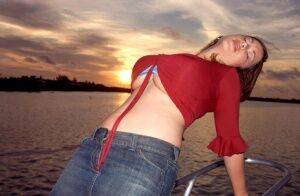 Solo girl Terry Nova slips a denim miniskirt over her butt on a sailboat on nudesceleb.com