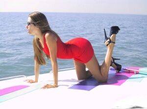 Solo girl Lori Anderson removes a red dress while getting naked atop a boat on nudesceleb.com