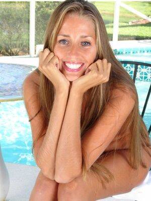 Amateur mom Lori Anderson making nude modeling debut beside swimming pool on nudesceleb.com