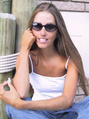 Amateur woman Lori Anderson dons sunglasses while playing with her hairy arms on nudesceleb.com