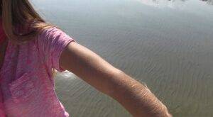 Amateur chick Lori Anderson shows off incredibly hairy forearms by the water on nudesceleb.com