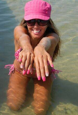 Amateur model Lori Anderson shows her hairy arms while wearing a bikini on nudesceleb.com