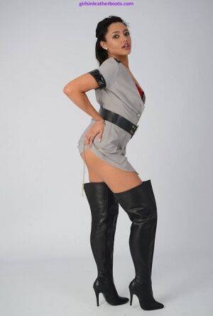 Solo model wears thigh high leather boots and uniform during non nude action on nudesceleb.com