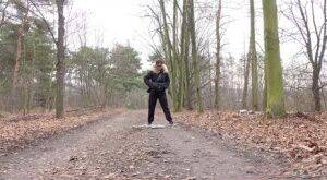 Solo girl Natasha Ink squats for a pee on a dirt road in glasses and a coat on nudesceleb.com