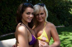 Lesbian girls Natasha and Kelly release their tits from bikini tops in a yard on nudesceleb.com