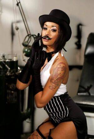 Ebony pornstar Skin Diamond strutting in vintage hat and long gloves on nudesceleb.com