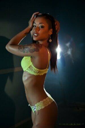 Sexy ebony Skin Diamond sheds yellow hot lingerie to pose naked on the stage on nudesceleb.com