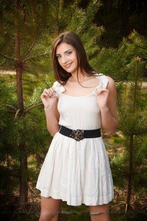 Nice teen Alisee D stands naked in the woods after removing white dress on nudesceleb.com