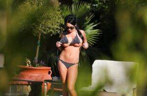 Kitty Bella gets caught on a voyeur photo tanning naked outdoor on nudesceleb.com