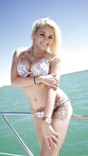 Busty young babe Marsha May exposing large teen tits on boat on nudesceleb.com