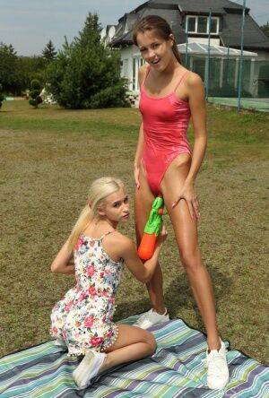 Slim teens Cindy Shine & Kiara Cole share double dildo after a water fight on nudesceleb.com