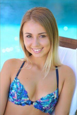 Sweet wild teen in bikini shows her tiny tits and bald twat by the pool on nudesceleb.com