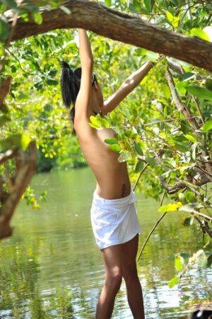 Slender teen with exotic looks Uris strikes nude poses in a river on nudesceleb.com