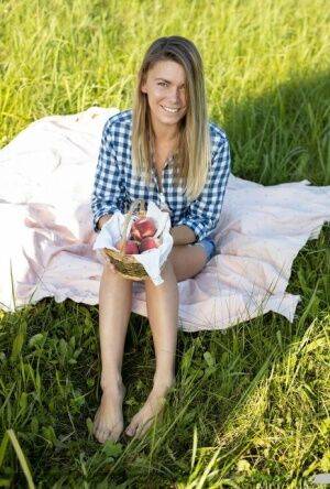 Nice teen Paulina gets completely naked on a blanket in a field on nudesceleb.com