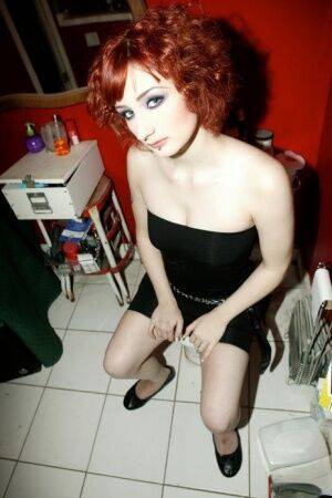 Pale redhead Violet Monroe gets naked in flat shoes while in a bathroom on nudesceleb.com