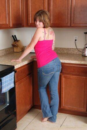 Plump solo girl removes her jeans on hr way to posing nude on kitchen floor on nudesceleb.com