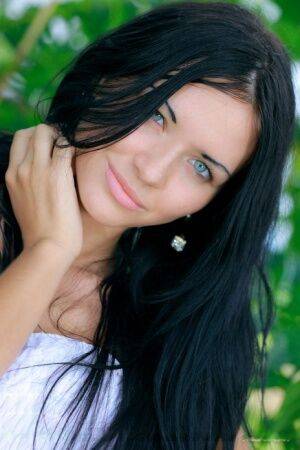 Dark haired Russian teen Kitti A strips totally naked under a tree - Russia on nudesceleb.com