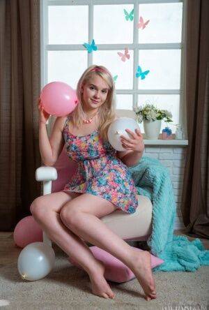 Young blonde Riya gets butt naked amid a bunch of balloons on nudesceleb.com