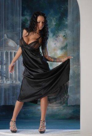 Leggy Latina chick Angelina Valentine removes a long black dress to pose nude on nudesceleb.com