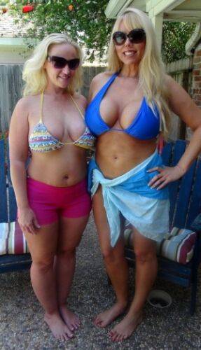 Blonde women Karen Fisher and Dee Siren loose their big tits from bikini tops on nudesceleb.com