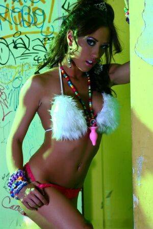 Hot MILF Capri Cavanni peels off her bikini amid graffiti in furry boots on nudesceleb.com