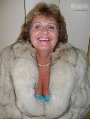 Chubby mature woman Busty Bliss releases her tan lined tits from a fur coat on nudesceleb.com