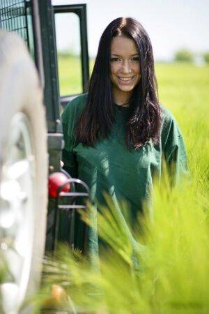 Dark haired girl Gwen A strips naked on top of a Land Rover on safari on nudesceleb.com