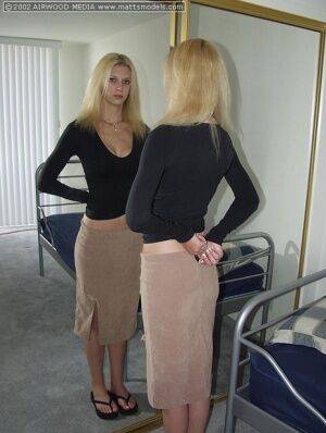 Tall blonde Brooke admires her ass in a mirror before getting naked on a bed on nudesceleb.com