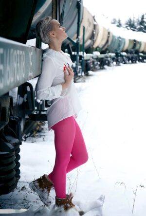 Short haired female displays her snatch by a train in crotchless hose on nudesceleb.com
