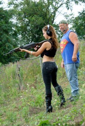 Latina teenager Gigi Rivera goes topless while firing off a rifle in woods on nudesceleb.com