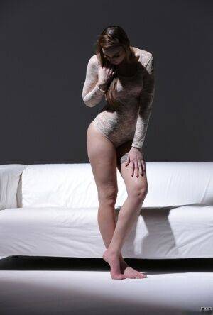 Bare legged solo model Lulu Love shows off her pretty feet in a onesie on nudesceleb.com