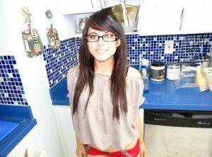 Nerdy teen Oxuanna Envy flaunts her bare ass after a kitchen handjob on nudesceleb.com