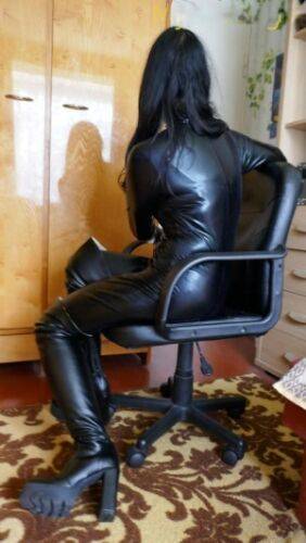 Amateur model poses in a leather cat suit paired with shades and boots on nudesceleb.com