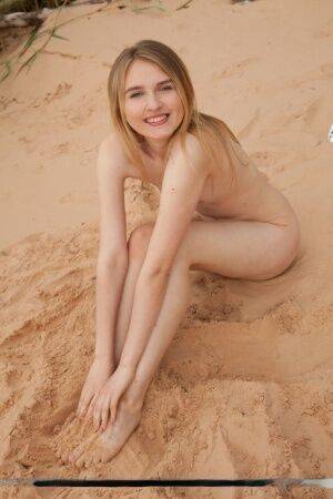 Cute teen girl Lia Kate gets totally naked on a sandy beach on nudesceleb.com